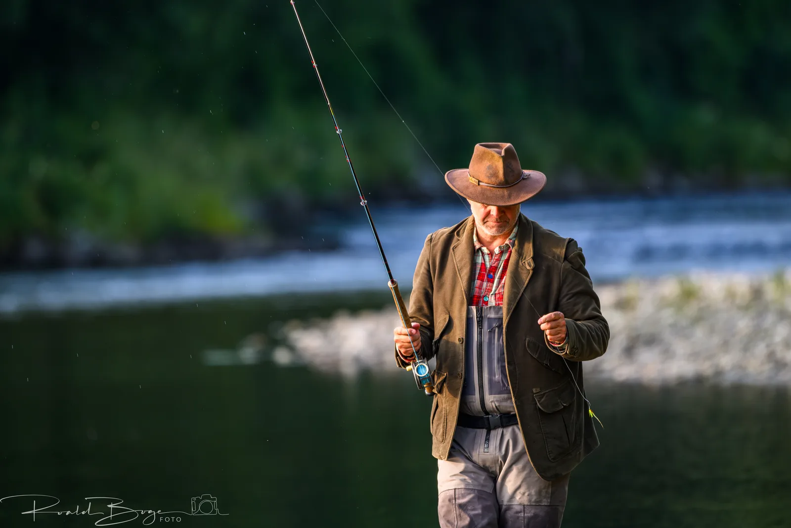 Fly fisher in tweed by the river