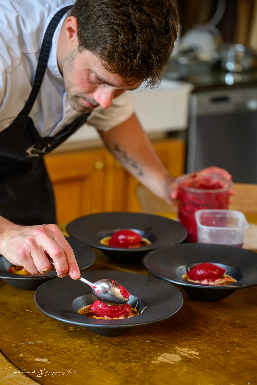 Dessert being plated with tweezers