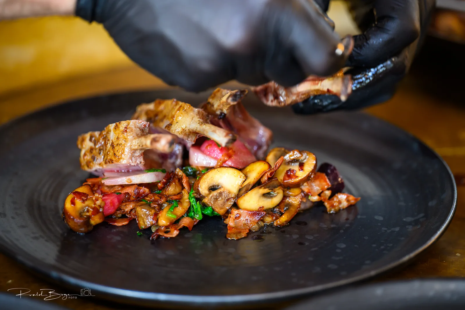 Lamb course on a black plate